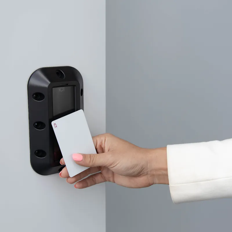 image of somebody badging against a reader with a vandal resistant cover