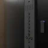 An access control reader and keypad mounted beside an elevator door in an apartment building