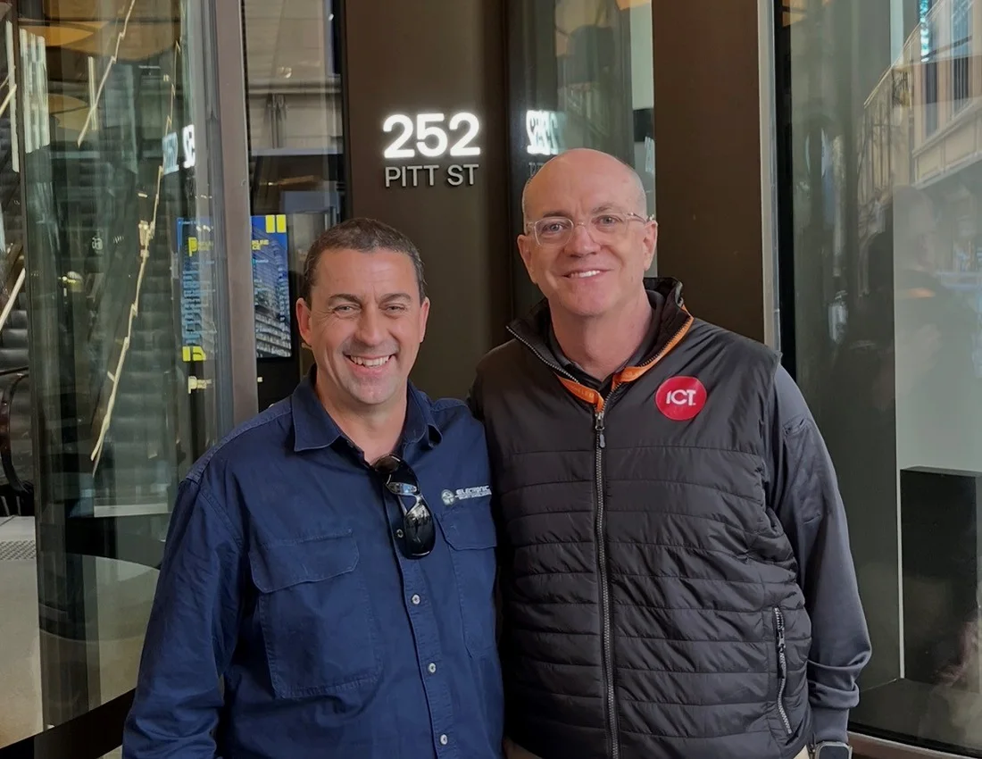 Two people standing side by side at the Parkline Place street entrance