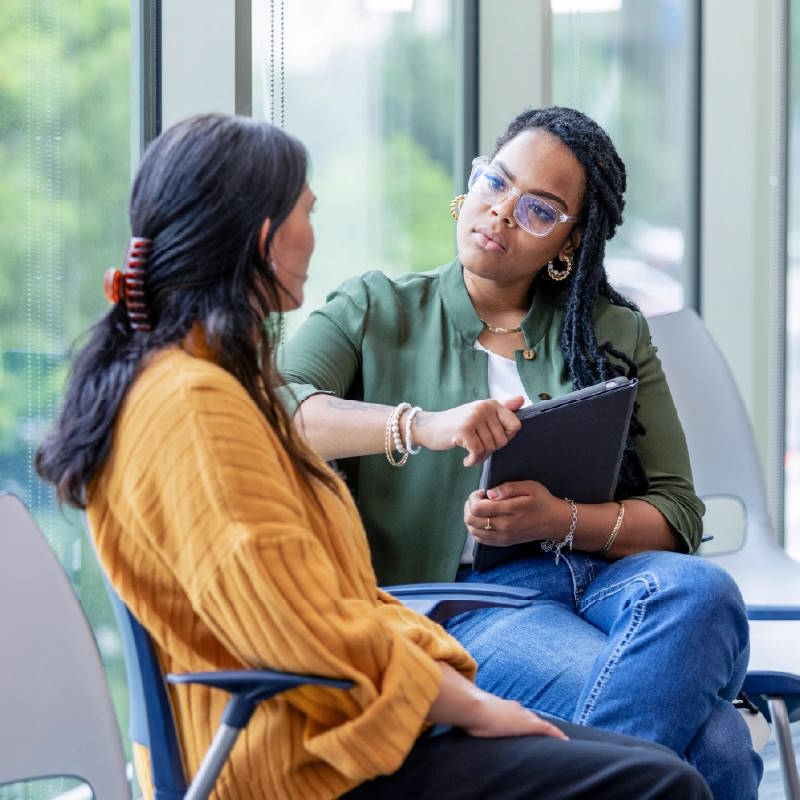 a staff member talking to a patient in a behavioral health facility