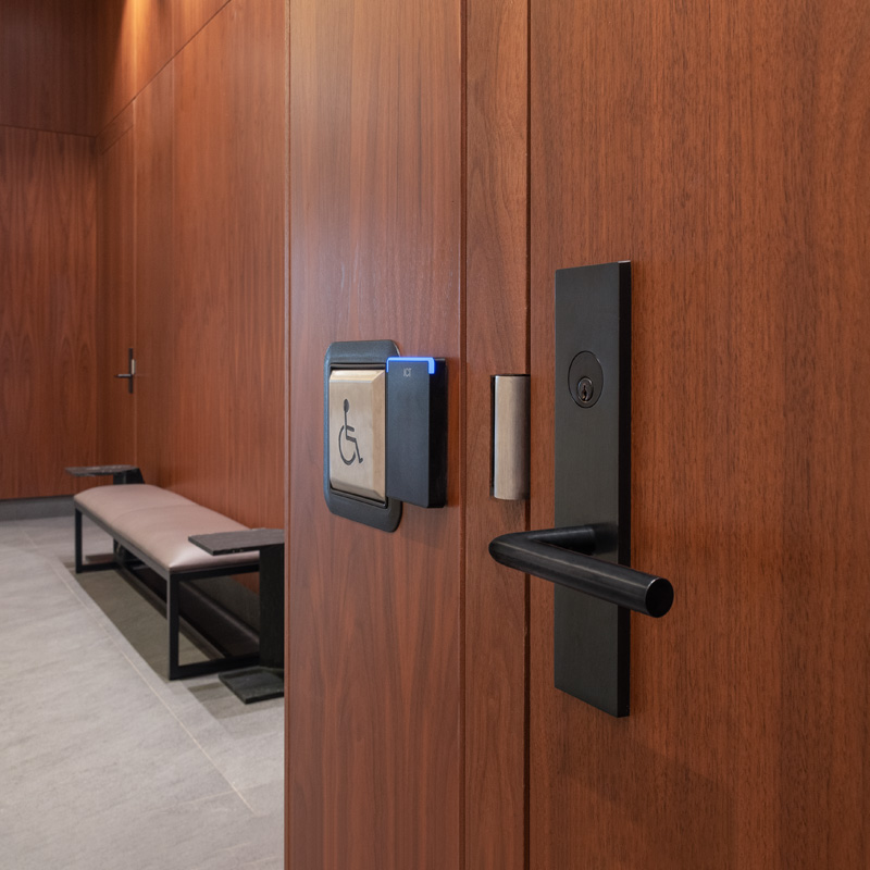 Wooden door with lock, access control reader, and wheelchair button