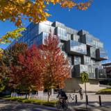 Pharmaceutical Sciences building at University of British Columbia with fall trees in the foreground